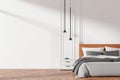 Modern bedroom interior with a cozy bed and empty wall for design mockup. 3D Rendering Royalty Free Stock Photo