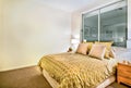 Modern bedroom interior in a luxurious apartment with king size bed Royalty Free Stock Photo