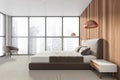 Modern bedroom interior in new luxury home. Stylish hotel room. Open space area. Wooden walls carpet floor. Panoramic window Royalty Free Stock Photo