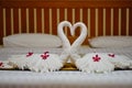 Modern bedroom interior setup on white blanket and wooden bed for honeymoon. Royalty Free Stock Photo