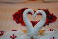 Modern bedroom interior setup on white blanket and wooden bed for honeymoon. Royalty Free Stock Photo