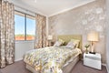 Modern bedroom with a master bed and light brown color curtain d Royalty Free Stock Photo