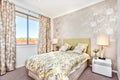 Modern bedroom with a master bed and light brown color curtain decorations of a luxury house Royalty Free Stock Photo