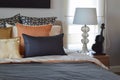 Modern bedroom with orange and gold pillows on bed Royalty Free Stock Photo