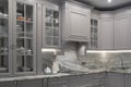 Modern beige and grey colored kitchen interior classic style with marble countertop in luxury apartment