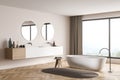 Modern beige panoramic bathroom with two round mirrors. Corner view
