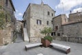 modern benches in little square at medieval hilltop village, Pitigliano, Italy Royalty Free Stock Photo