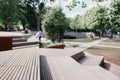 Modern benches and wooden stairs in city on a sunny day. Public places in  city park. Selective focus, blurred background. Royalty Free Stock Photo