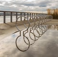 Modern bicycle rack with reflection after rain on the street of a city Royalty Free Stock Photo