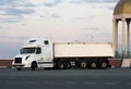 A modern big rig semi truck turns on highway