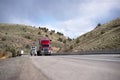 Modern big rigs convoy moving on the road between the hills in I Royalty Free Stock Photo