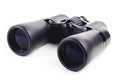 Modern binoculars in black on a white background. Lenses forward. Close-up. There is no isolation Royalty Free Stock Photo