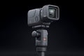 Modern Black Action Camera Mounted on a Tripod in Studio Against a Black Background Royalty Free Stock Photo