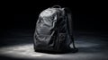 Modern Black Backpack for Travel and Everyday Use on Grey Surface Royalty Free Stock Photo