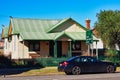 Modern BMW Sedan Parked Outside Old Weatherboard House, Australia