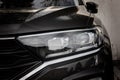 Modern black car xenon lamp headlight, front view close up. Modern car closeup of headlight Royalty Free Stock Photo