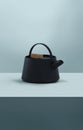 Modern black cast iron teapot with colorful minimalist background blue, art set for tea time. 3d rendering