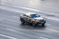 modern black crossover car BMW X4 is driving on highway on high speed
