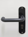 Modern black door handle on white background. Architecture detail. Front view Royalty Free Stock Photo