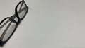black frame glasses for vision correction and style on bright white background with plenty of space for text Royalty Free Stock Photo