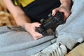 Modern black game controller in the hands of a seated young girl Royalty Free Stock Photo