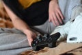 Modern black game controller in the hands of a seated young girl Royalty Free Stock Photo