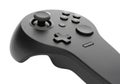 Modern black game controller with joystick, directional pad, and buttons on a white background Royalty Free Stock Photo