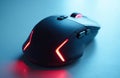 Modern black gaming computer mouse with red and blue LED lights glows on light blue surface. Wireless ergonomic peripheral used Royalty Free Stock Photo