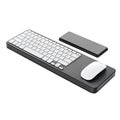 Modern black keyboard and white mouse on a black wrist rest with phone on white background Royalty Free Stock Photo