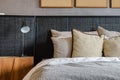 Modern black lamp on wooden table in bedroom at home