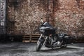 Modern black motorcycle stands against a brick wall Royalty Free Stock Photo