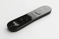 A modern black remote control with a sleek design and multiple buttons for various functions It represents technology control