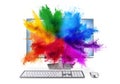 Modern black silver pc monitor with mouse and keyboard colorful rainbow holi powder cloud explosion through screen isolated white