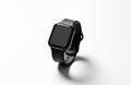 Modern black smartwatch with blank screen rests on white surface. Digital wearable device features sleek design, touch interface Royalty Free Stock Photo