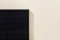 Modern black solar panel installed on white facade of modern house. Royalty Free Stock Photo