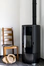 Modern black stove with pellet bag in a living room