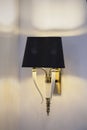 Modern black wall lamp with white fangs. Beautiful decor of a fashionable chandelier Royalty Free Stock Photo