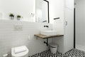 Modern black and white tiled floor cloakroom with white porcelain
