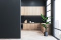 Modern black and wooden kitchen interior design with window and empty mock up place on wall. Royalty Free Stock Photo