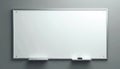 Modern blank whiteboard with metal frame hangs on gray wall. Includes marker tray and eraser. Ready for writing notes ideas Royalty Free Stock Photo