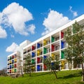 Modern block of flats with colorful balconies. Green living.