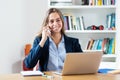 Modern blonde businesswoman speaking with customer at phone Royalty Free Stock Photo