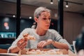 A modern blonde eating pizza in her office on a break from work Royalty Free Stock Photo
