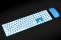 Modern blue aluminum computer keyboard and mouse isolated on black background. Royalty Free Stock Photo