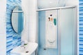 Modern blue bathroom interior with round mirror Royalty Free Stock Photo