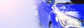 Modern blue car, close-up, blurred image. Panoramic background with place for text, copy space Royalty Free Stock Photo