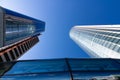 Modern blue glass office building skyscraper in the business center of a metropolis with reflections against the blue sky Royalty Free Stock Photo