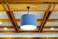 Modern blue hanging lamp on wooden ceiling