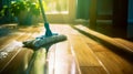 Modern blue mop with microfiber standing on the wooden parquet floor. Process of cleaning room. Concept supporting house hygiene Royalty Free Stock Photo