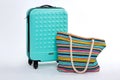 Modern blue suitcase, beach handbag. Royalty Free Stock Photo